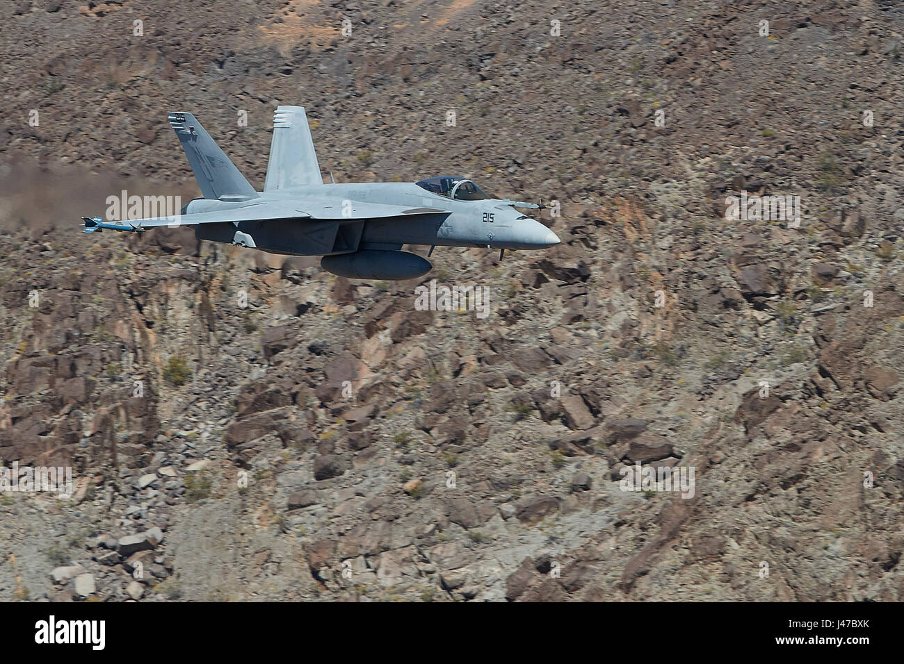 United States Navy F/A-18E, Super Hornet, Flying At High Speed And Low Level. Through A Desert Canyon. Stock Photo