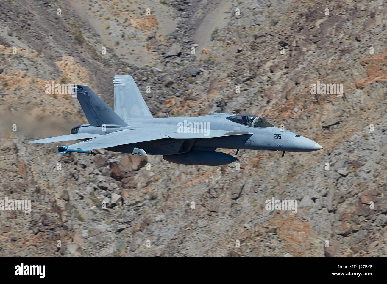 United States Navy F/A-18E, Super Hornet, Flying At High Speed And Low Level. Through A Desert Canyon. Stock Photo