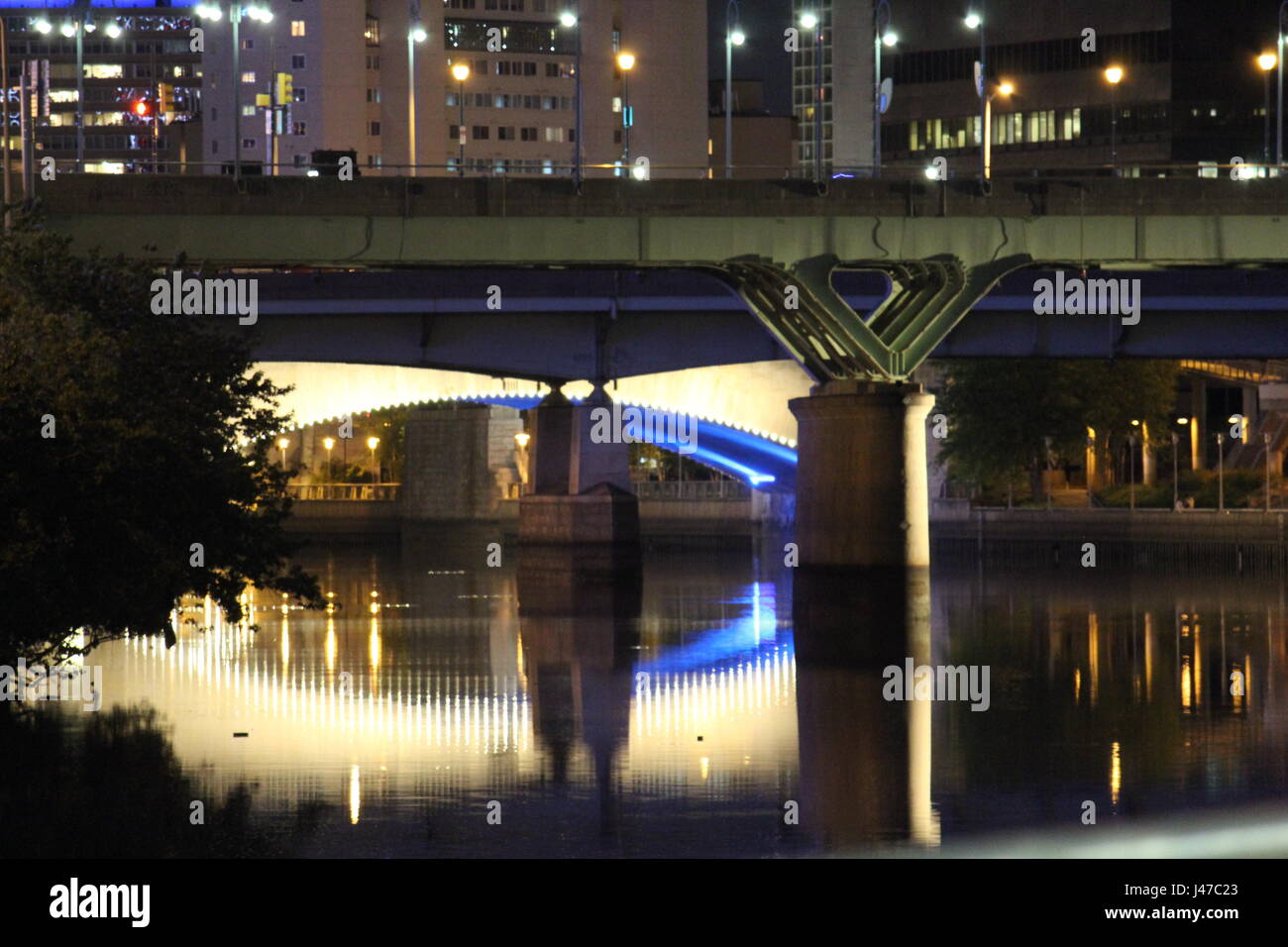 City bridge overlooking river reflection Stock Photo
