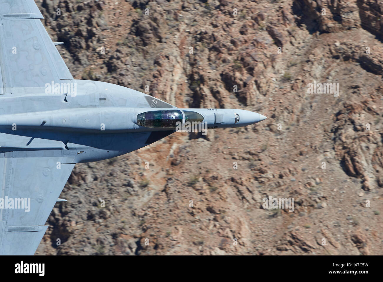 Abstract Photo Of A United States Navy F/A-18E, Super Hornet, Single Seat Jet Fighter, Flying At High Speed And Low Level Through A Desert Canyon. Stock Photo