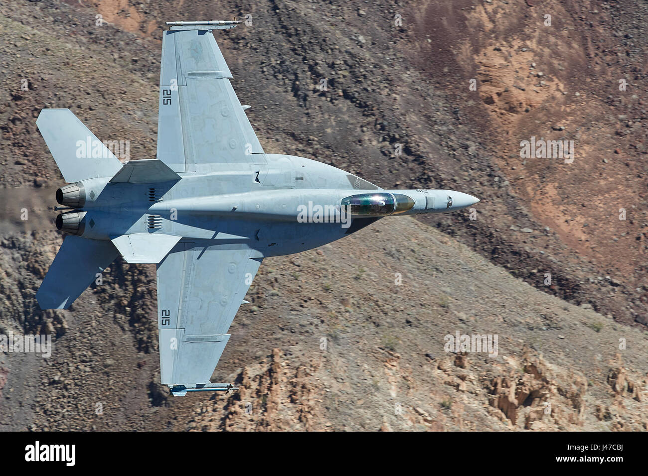 United States Navy F/A-18E, Super Hornet, Flying At High Speed And Low Level Through A Desert Canyon. Stock Photo