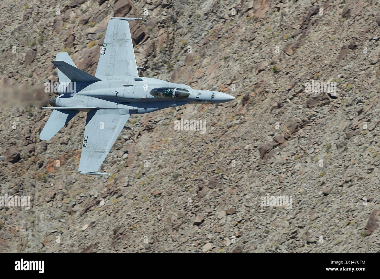 United States Navy F/A-18C, Hornet, Flying At High Speed And Low Level. Through A Desert Canyon. Stock Photo