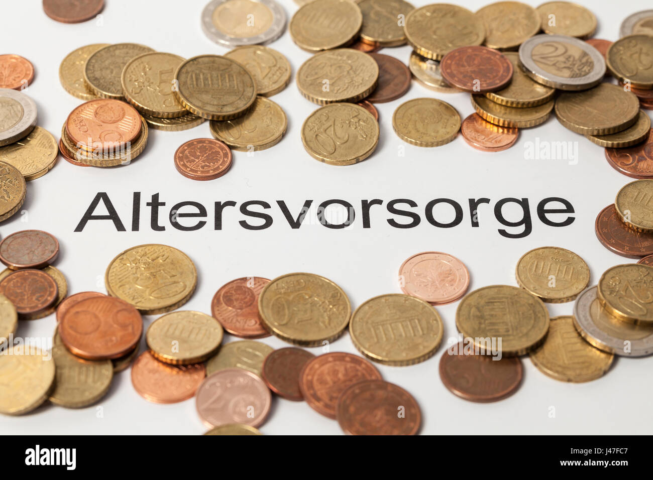 Altersvorsorge (pension plan in german) and Euro coins Stock Photo