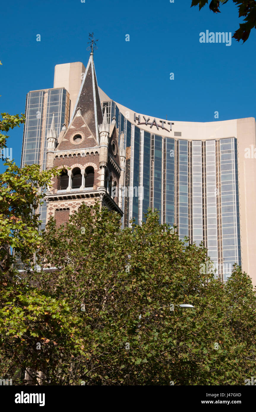 Spire of St Michael’s Uniting Church (1867) with the upscale Grand Hyatt Hotel beyond Stock Photo