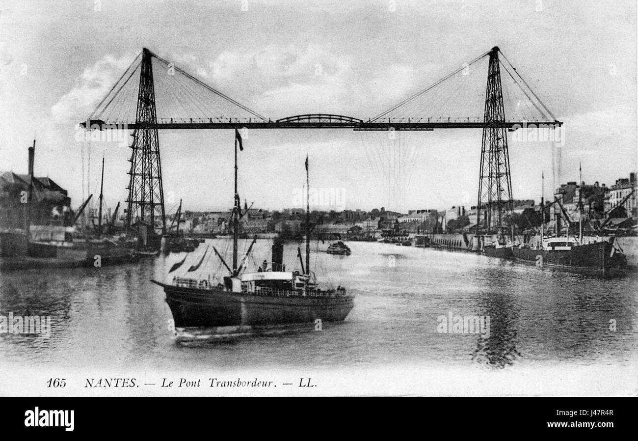 The Nantes Pont Transbordeur was a unique bridge in Nantes, France, used for transferring passengers and vehicles across the Loire River. This image likely documents the bridge's role in transportation history. Stock Photo