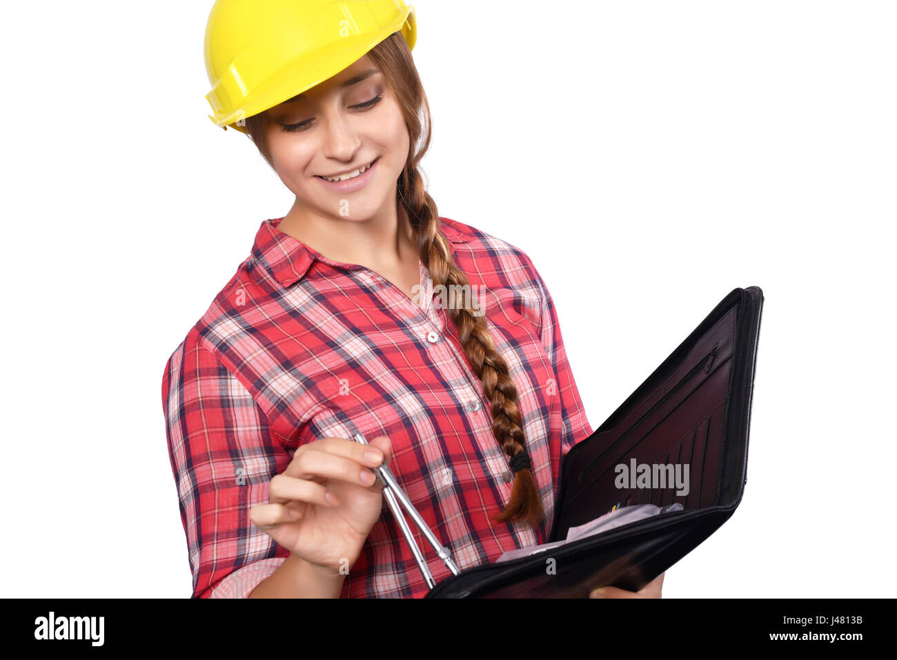 Portrait of beautiful woman construction worker reading blueprints with a compass. Isolated white background. Stock Photo