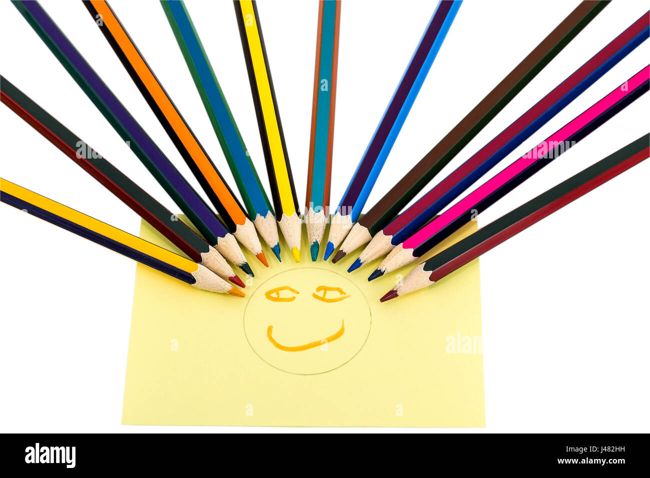 Smiley from colored pencils and yellow sticker with painted face, isolated on white background Stock Photo