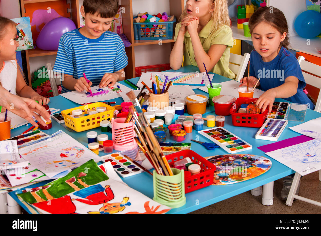 Small students girl and boy painting in art school class Stock Photo ...