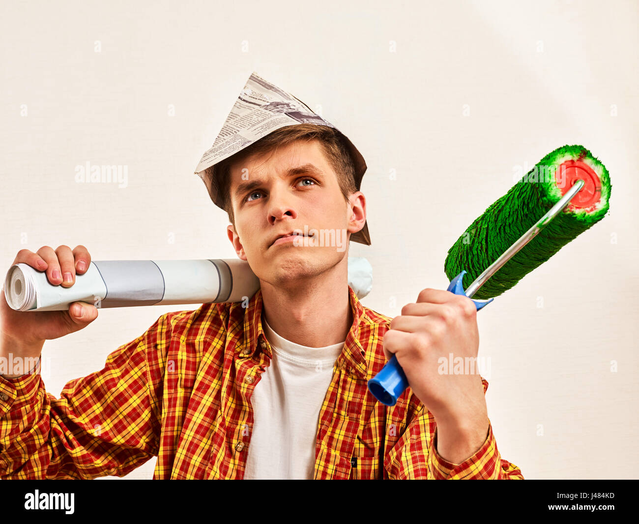 Repair home man holding paint roller for wallpaper Stock Photo Alamy