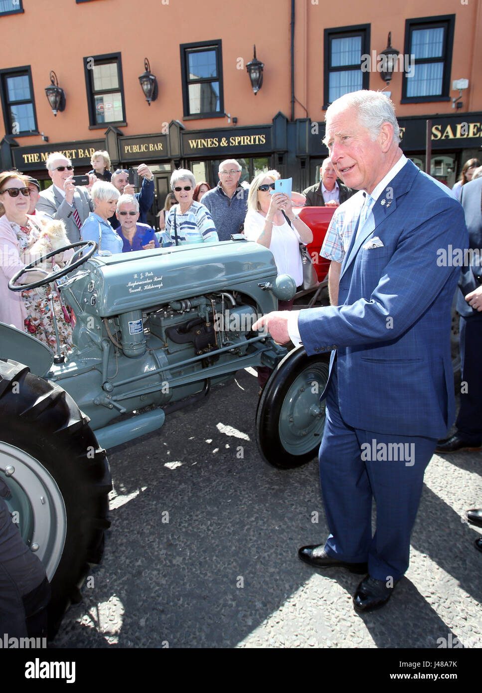 The Prince of Wales points to a tractor in Dromore Village in County Down, during a visit to