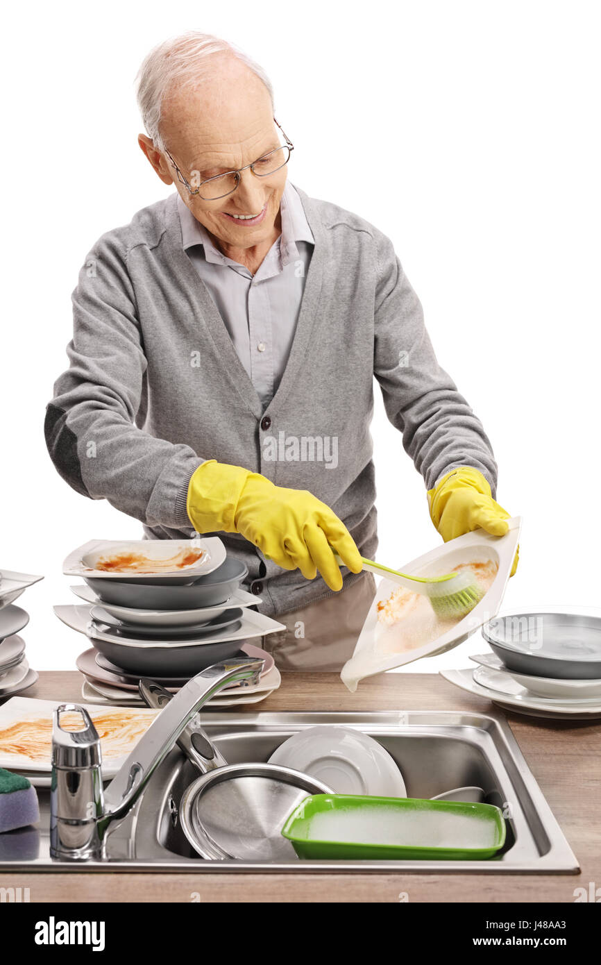Elderly man doing the dishes isolated on white background Stock Photo Alamy