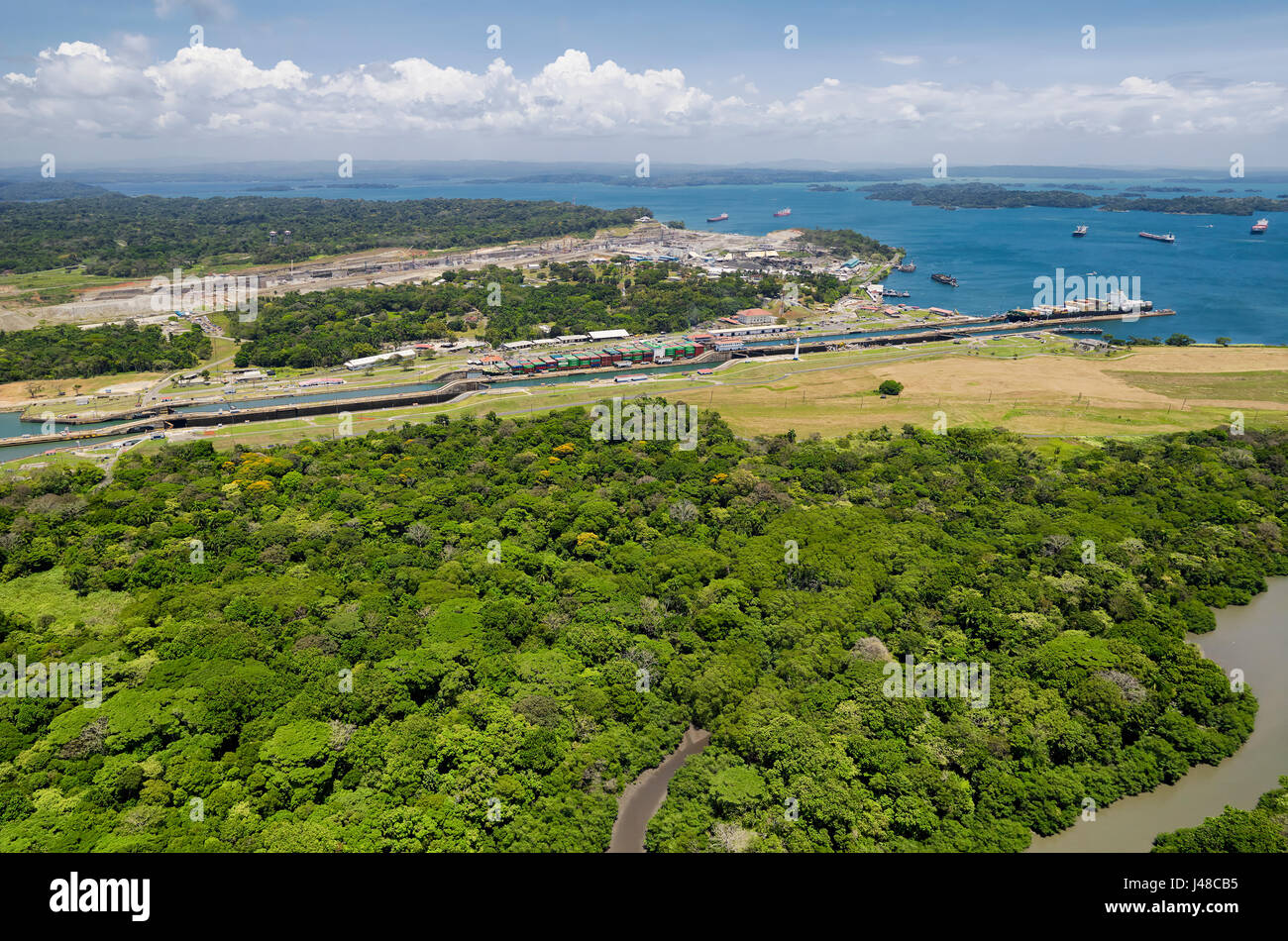 Panoramic aerial view of Gatun Locks with cargo ships passing through, Panama Canal Stock Photo