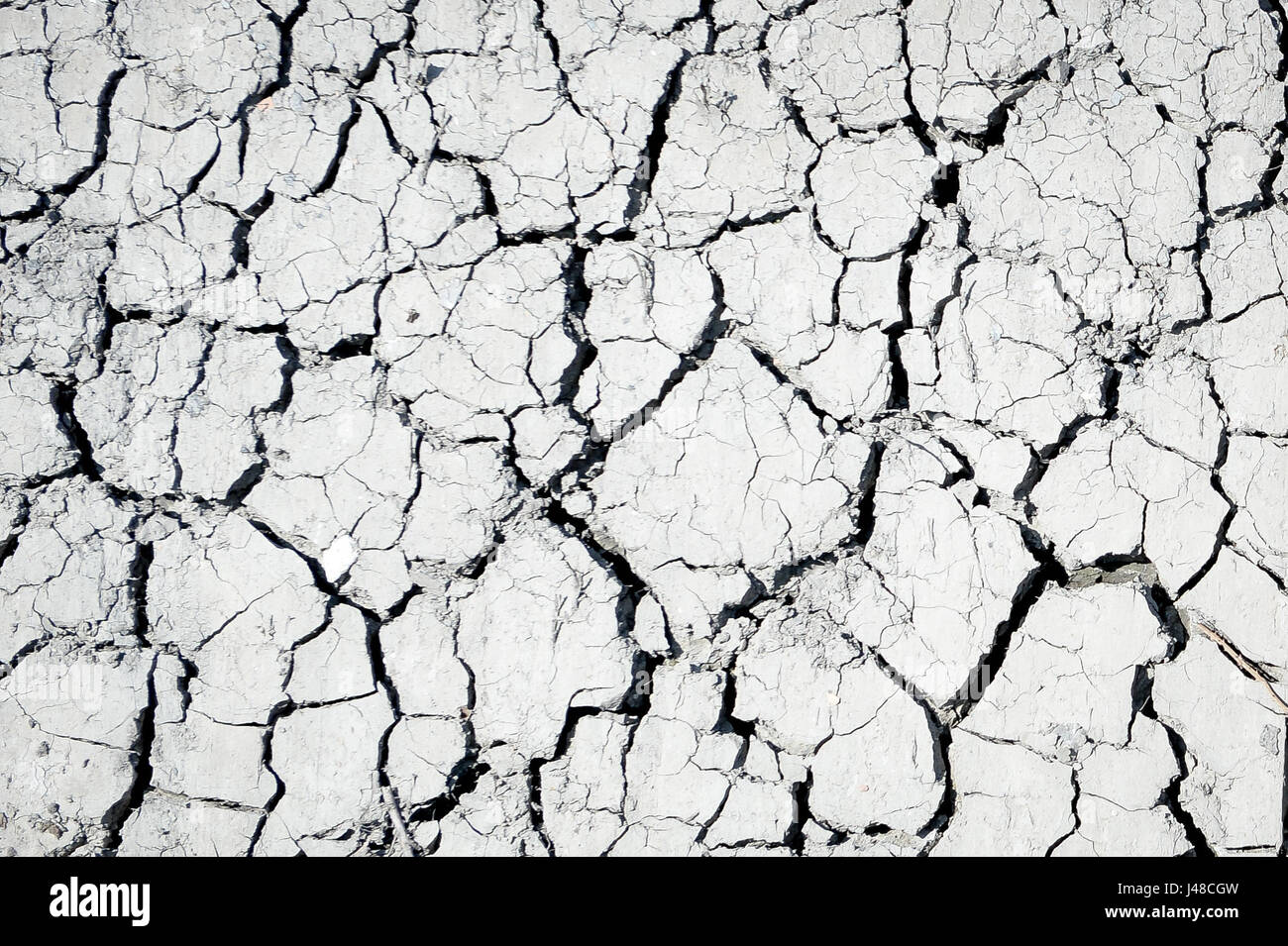 Cracked mud is exposed on a drainage ditch next to a field on the Somerset Levels as fears grow for a summer drought, following one of the driest winters in the past two decades. Stock Photo