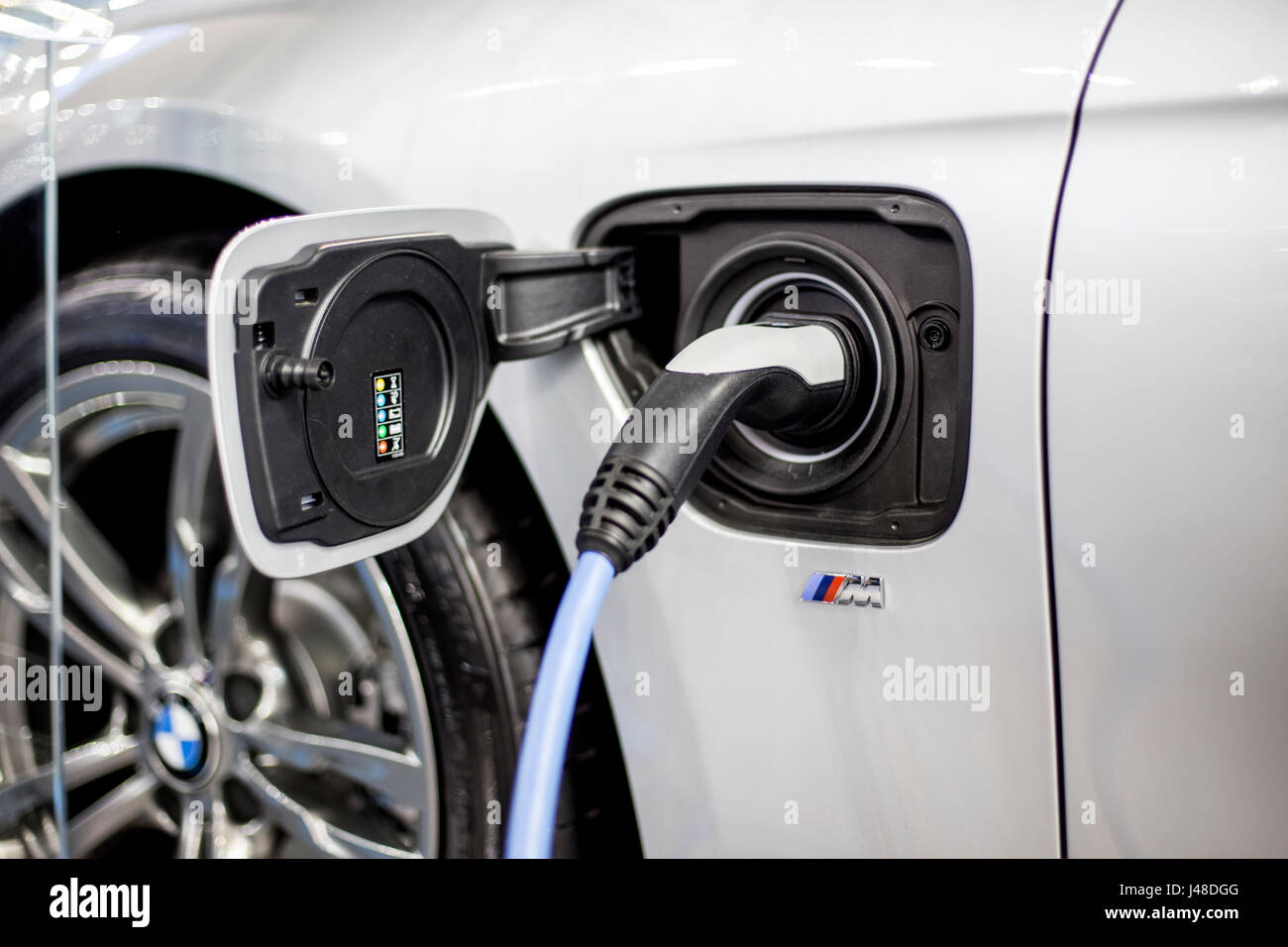 Recharging of hybrid BMW car. BMW ActiveHybrid technology unites a ...