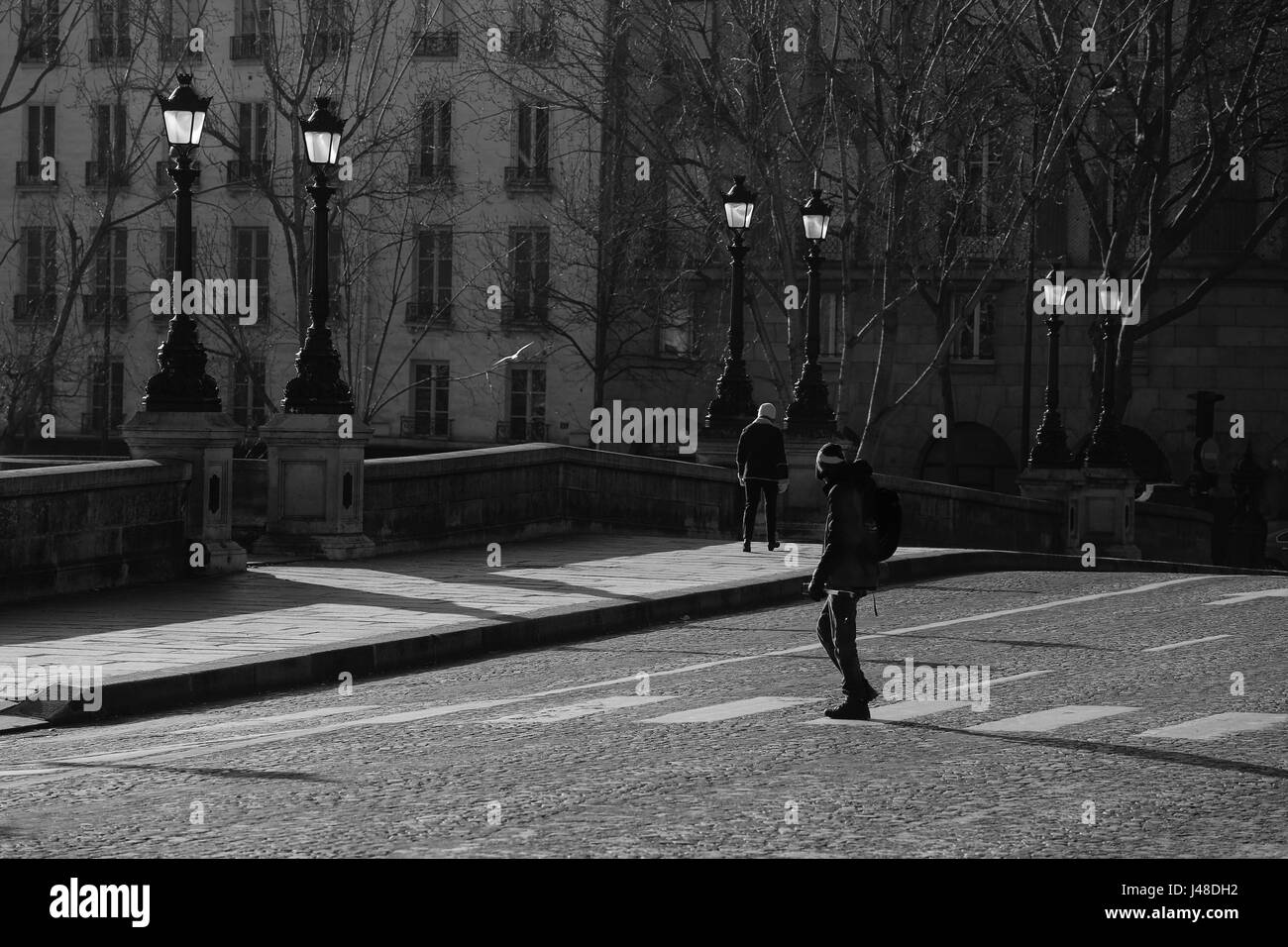 Young Parisian man crossing the street , Black and White image Stock Photo