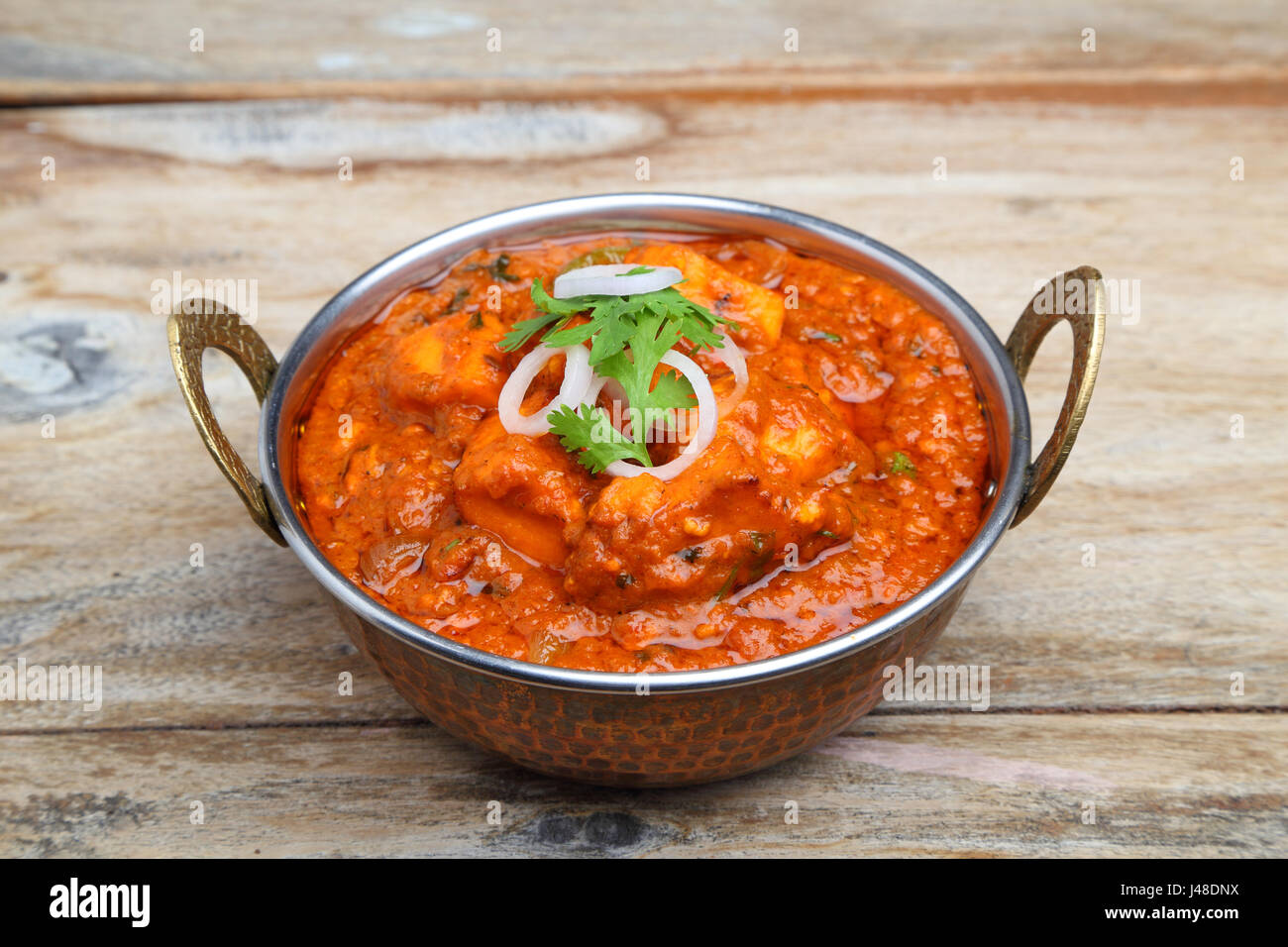 Indian Food or Indian Curry in a copper brass serving bowl Stock Photo