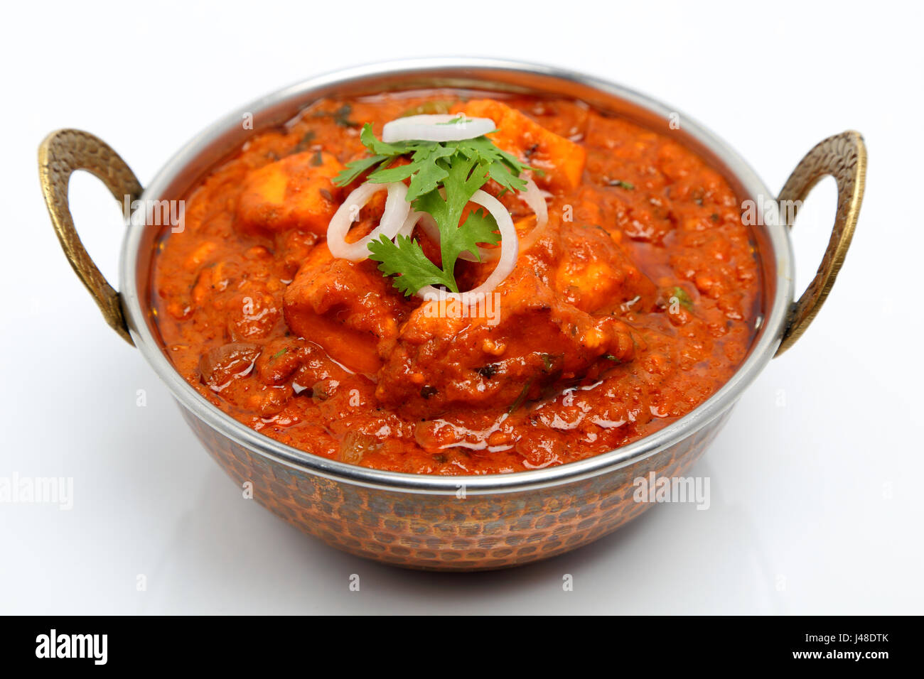 Indian Food or Indian Curry in a copper brass serving bowl Stock Photo