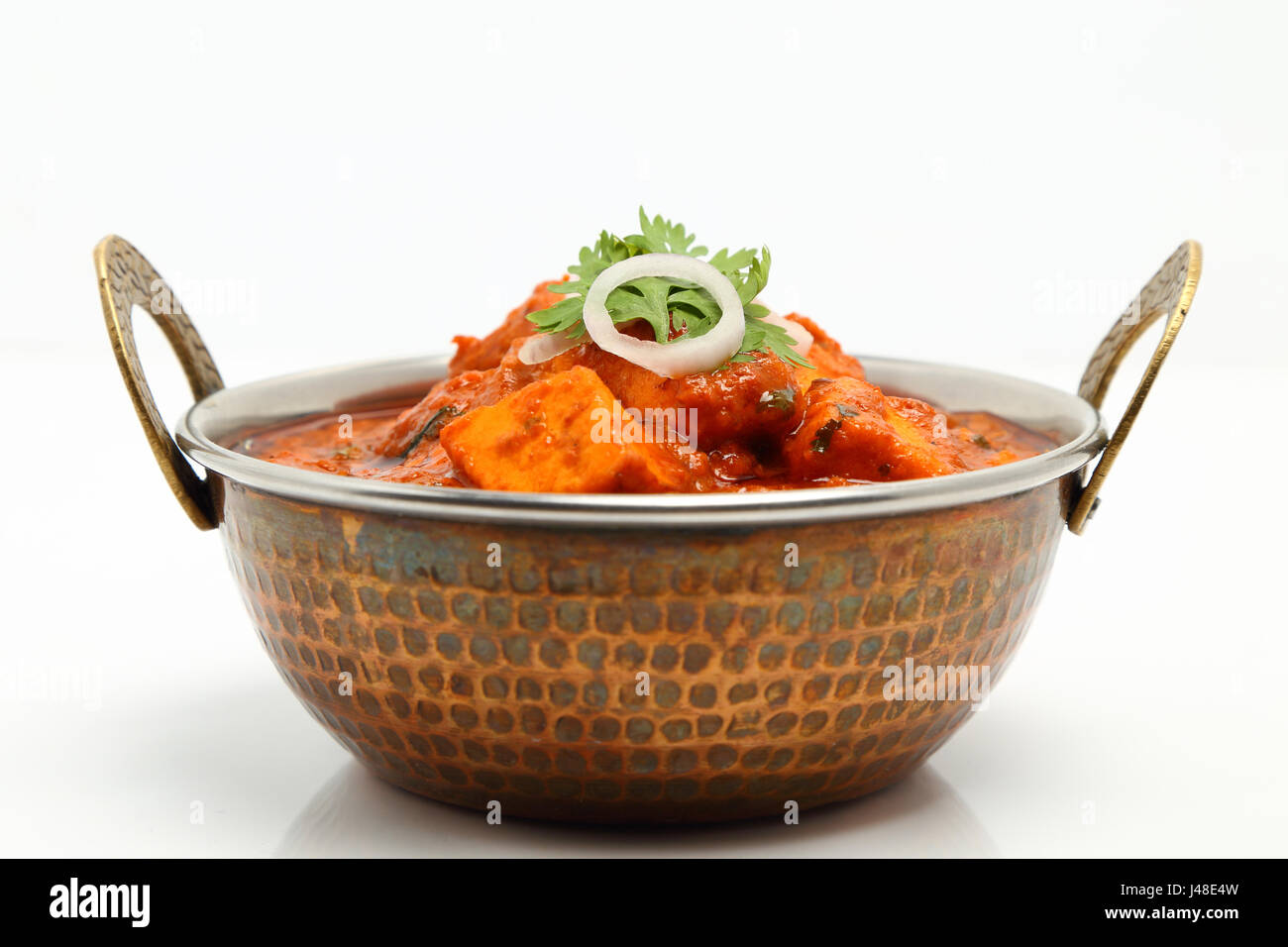 Indian Food or Indian Curry in a copper brass serving bowl Stock Photo