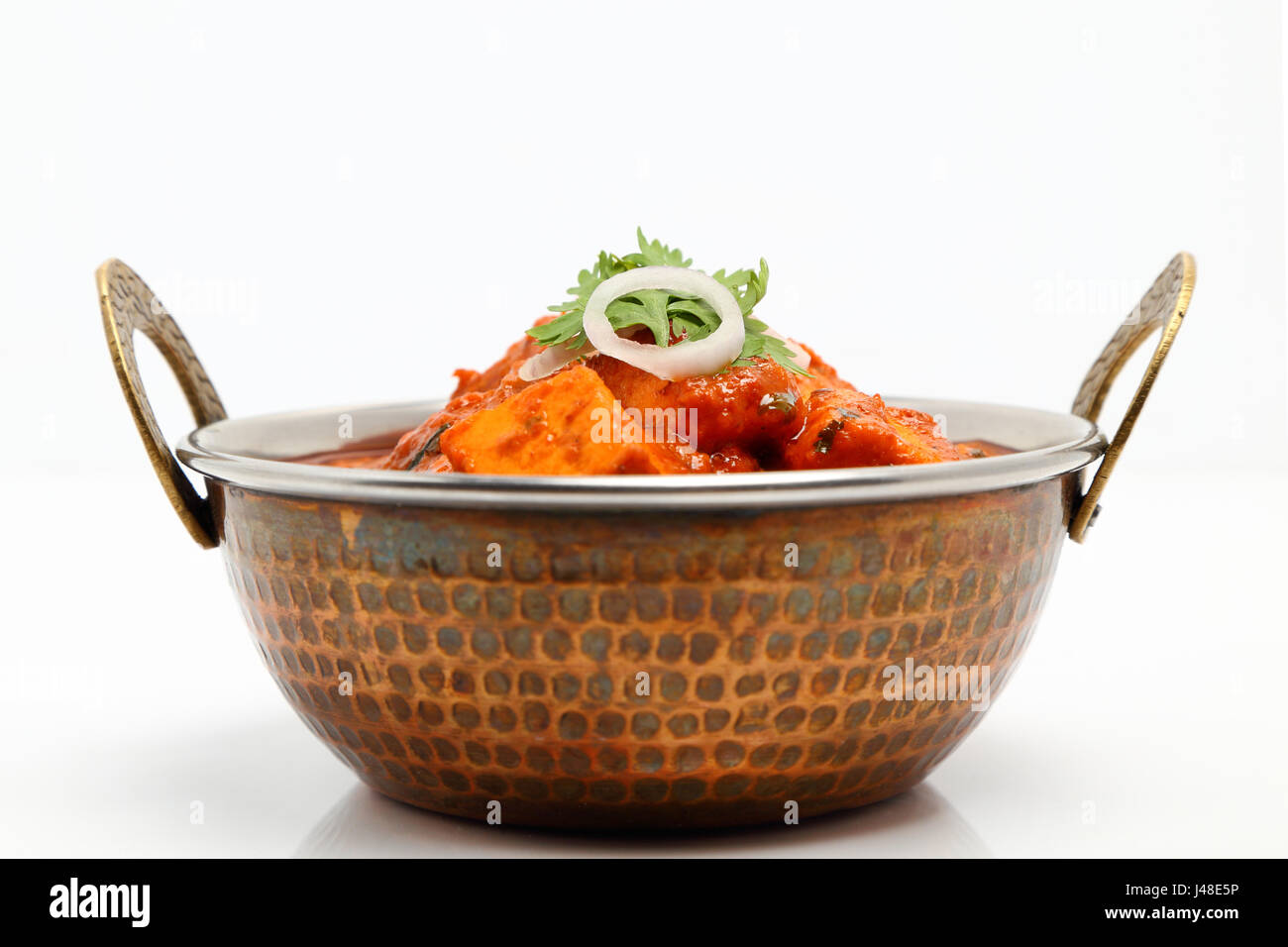 Indian Food or Indian Curry in a copper brass serving bowl Stock Photo
