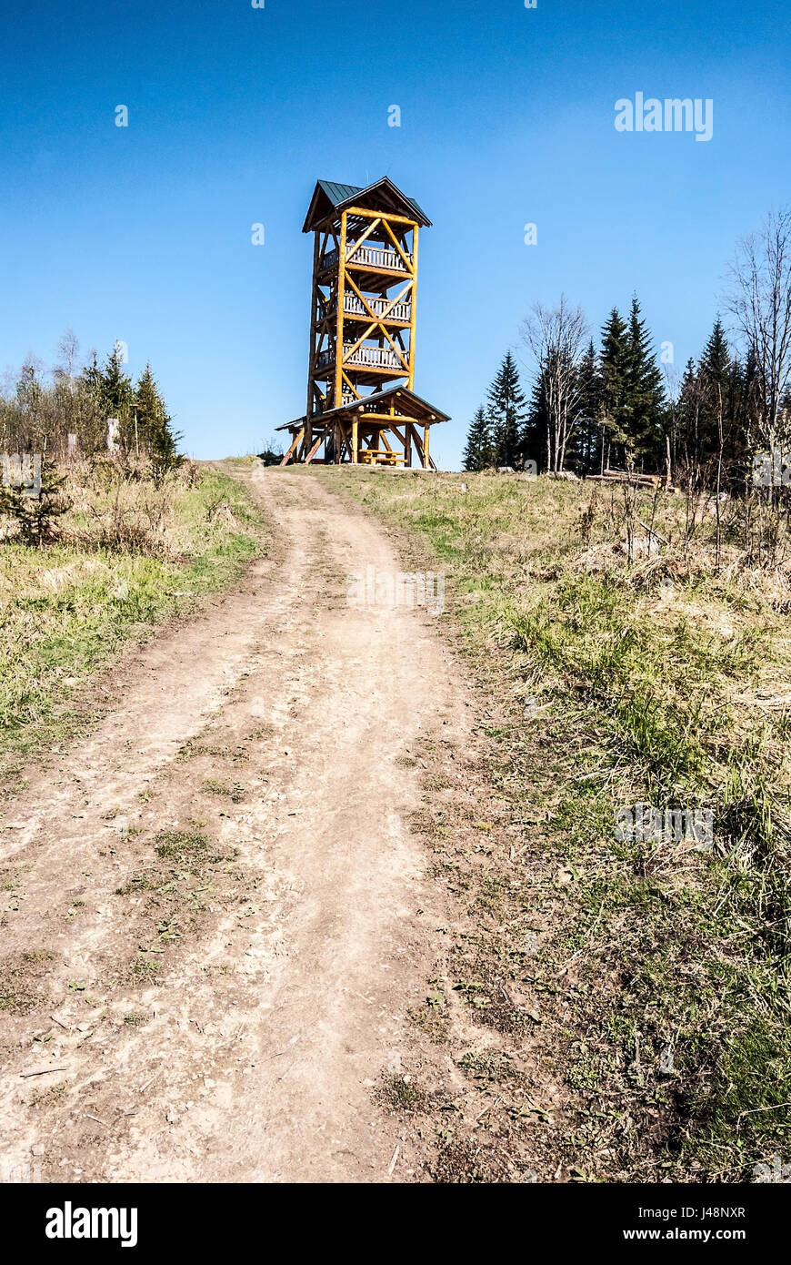 Tabor hill above Kysucke Nove Mesto city in Javorniky mountains in Slovakia with wooden view tower, and trail during spring day with clear sky Stock Photo