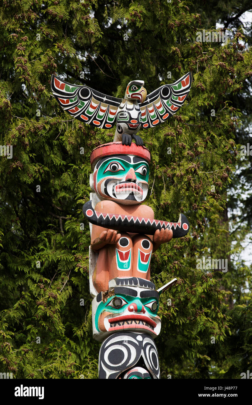 Totem pole at Brockton Point in Stanley Park in Vancouver, Canada. Nine totem poles stand in the park and are British Columbia's most popular tourist  Stock Photo