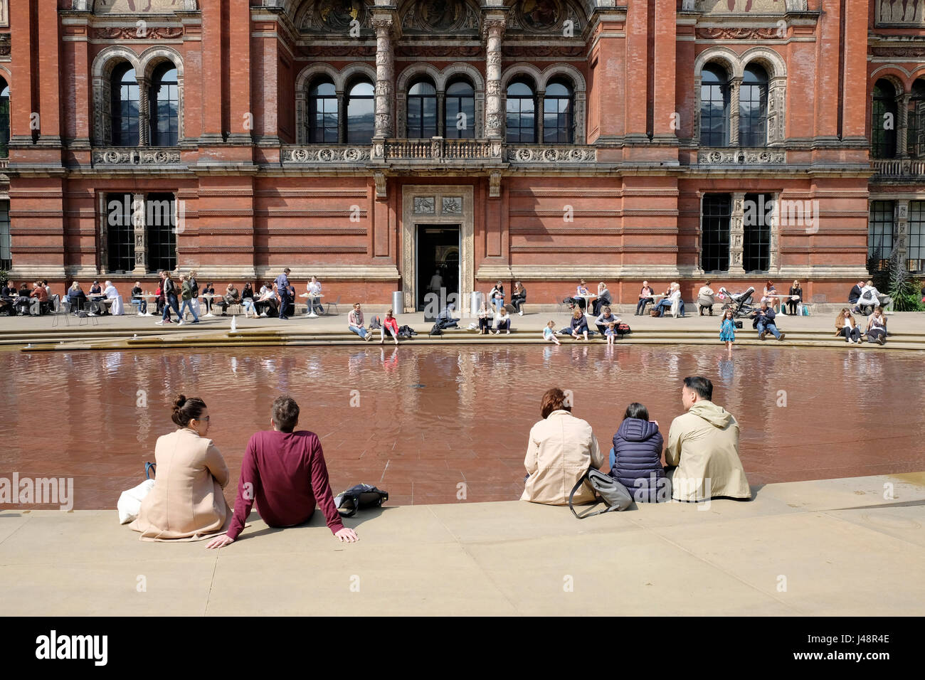People relaxing at the John Madejski garden, Victoria and Albert Museum, London. Stock Photo