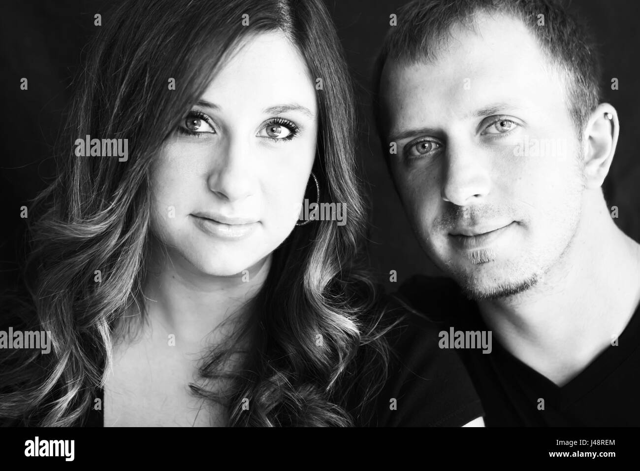 Portrait of a young couple against a black background; Oregon, United States of America Stock