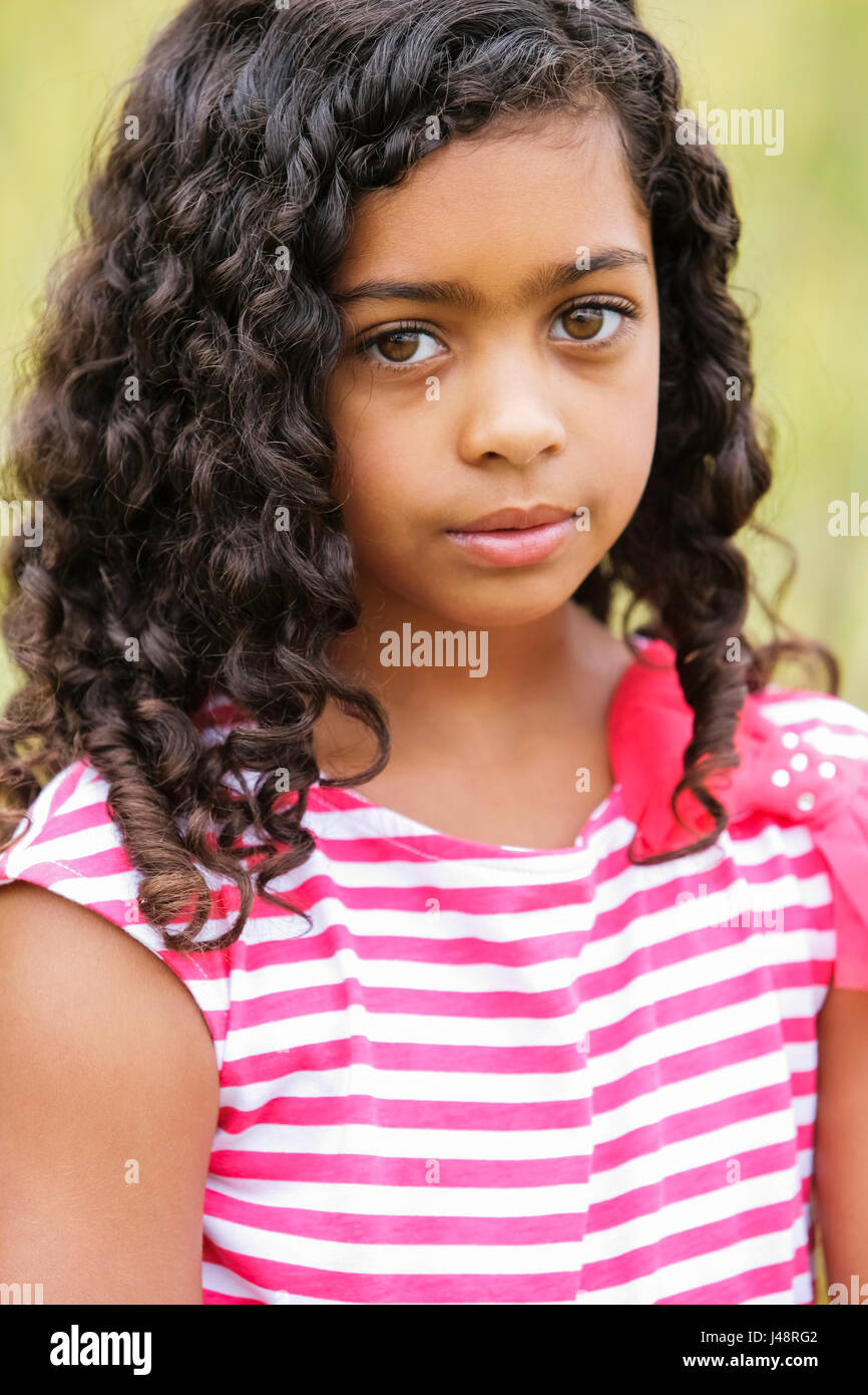Portrait Of A Young Girl With Dark Curly Hair And Big Brown