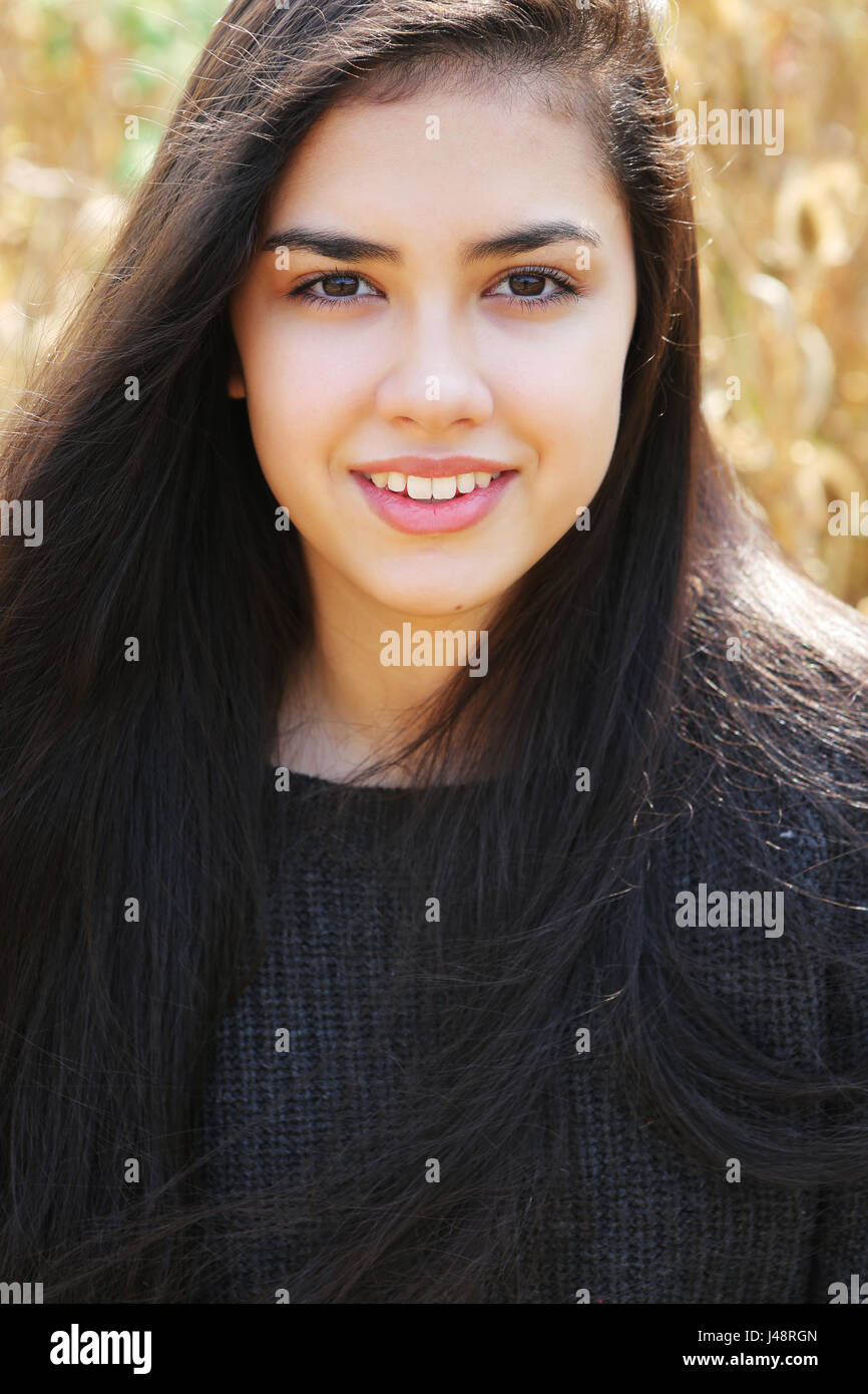 Portrait Of A Teenage Girl With Long Brown Hair And Brown Eyes