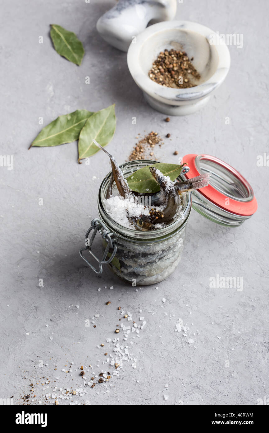 Preparing the salted capelin. Fish preserved for eating Stock Photo - Alamy