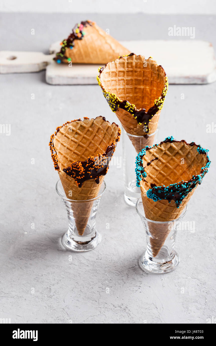 Homemade chocolate dipped ice cream cones with candy confetti and