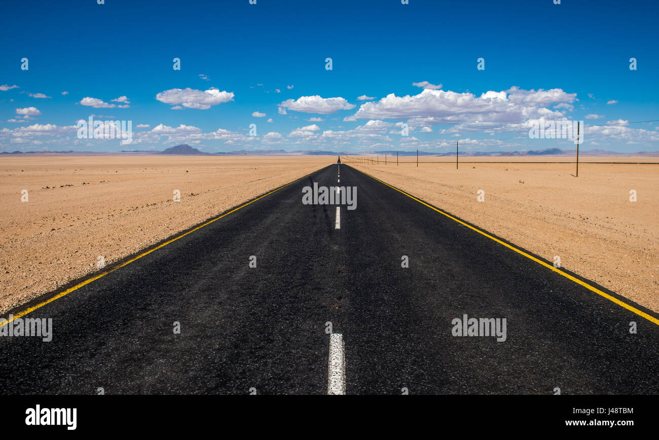 vibrant image of highway and blue cloudy sky Stock Photo - Alamy