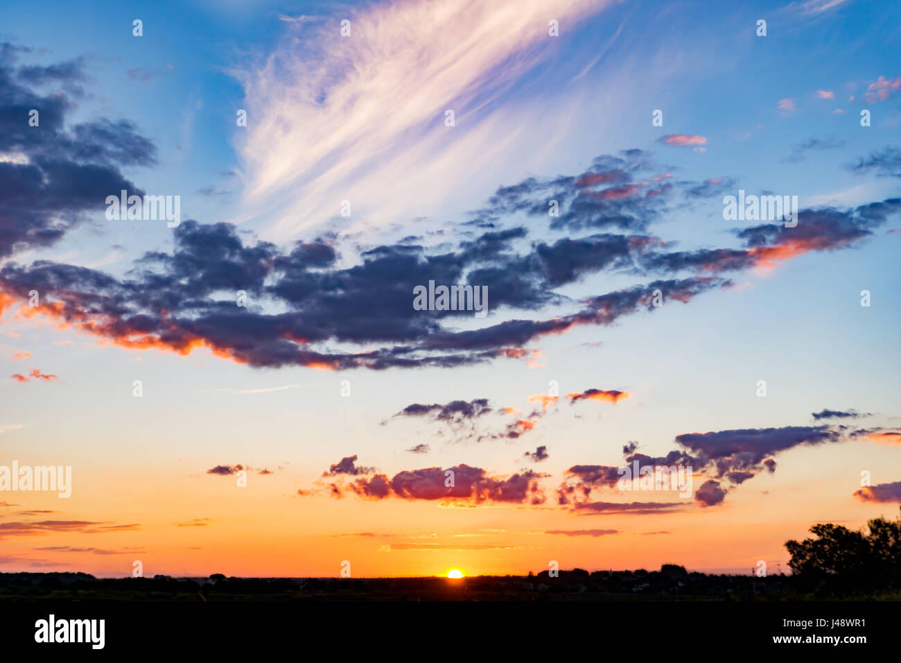 Dramatic landscape sunset. Bright colorful sky and clouds Stock Photo ...