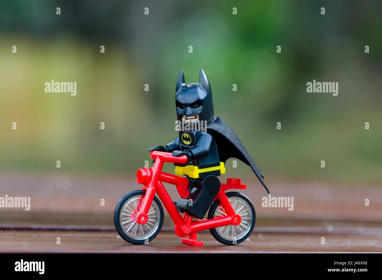 Lego batman minifigures riding bicycle. Stock Photo