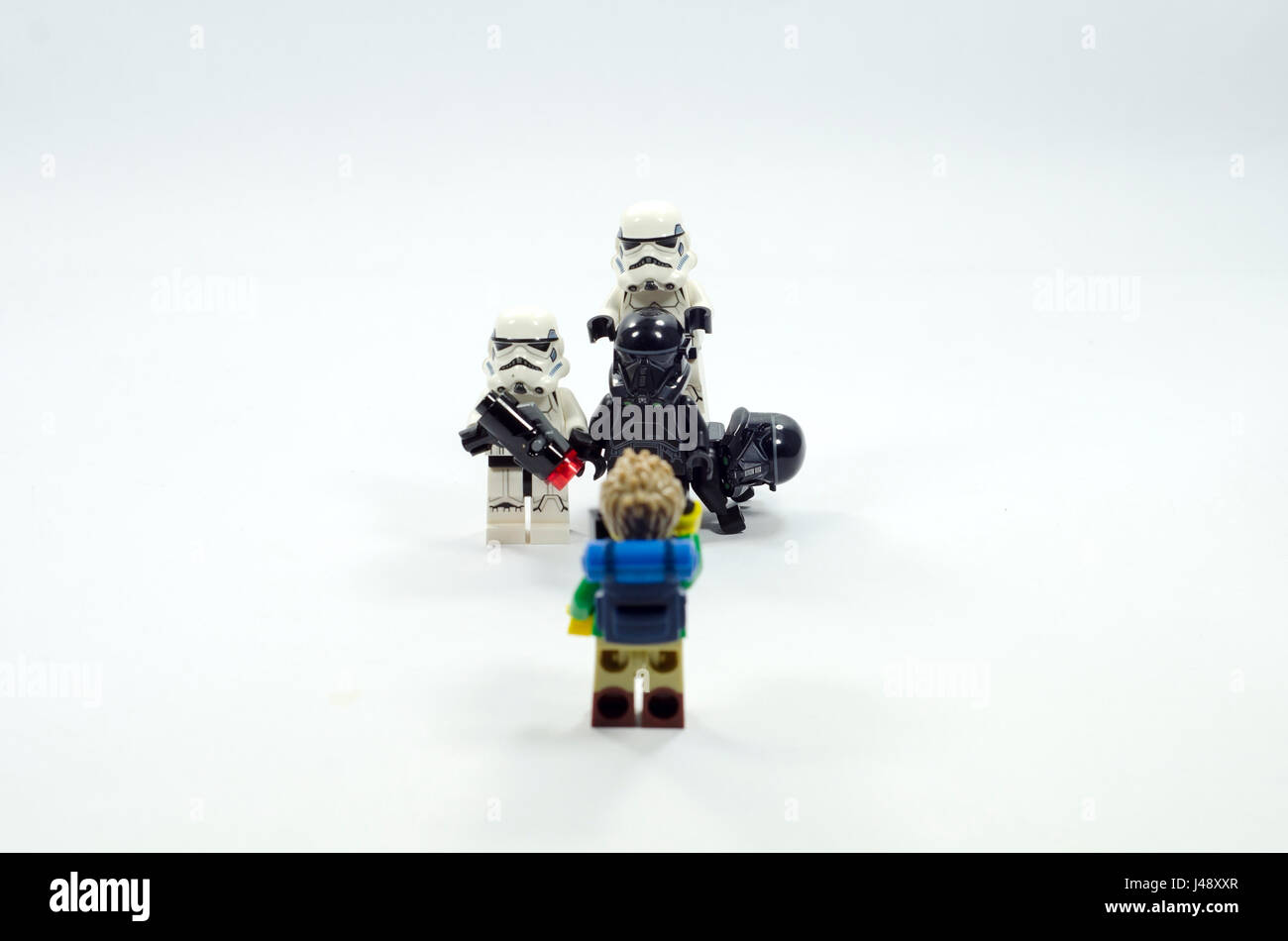 Lego hiker taking pictures group of storm troopers isolated on whites background. Stock Photo