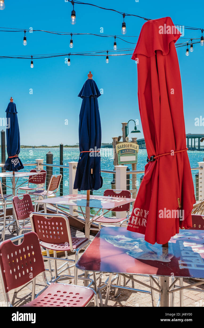 Empty waterside patio dining tables at Harry T's restaurant, at the Harbor Walk Marina, Destin Florida, USA. Stock Photo