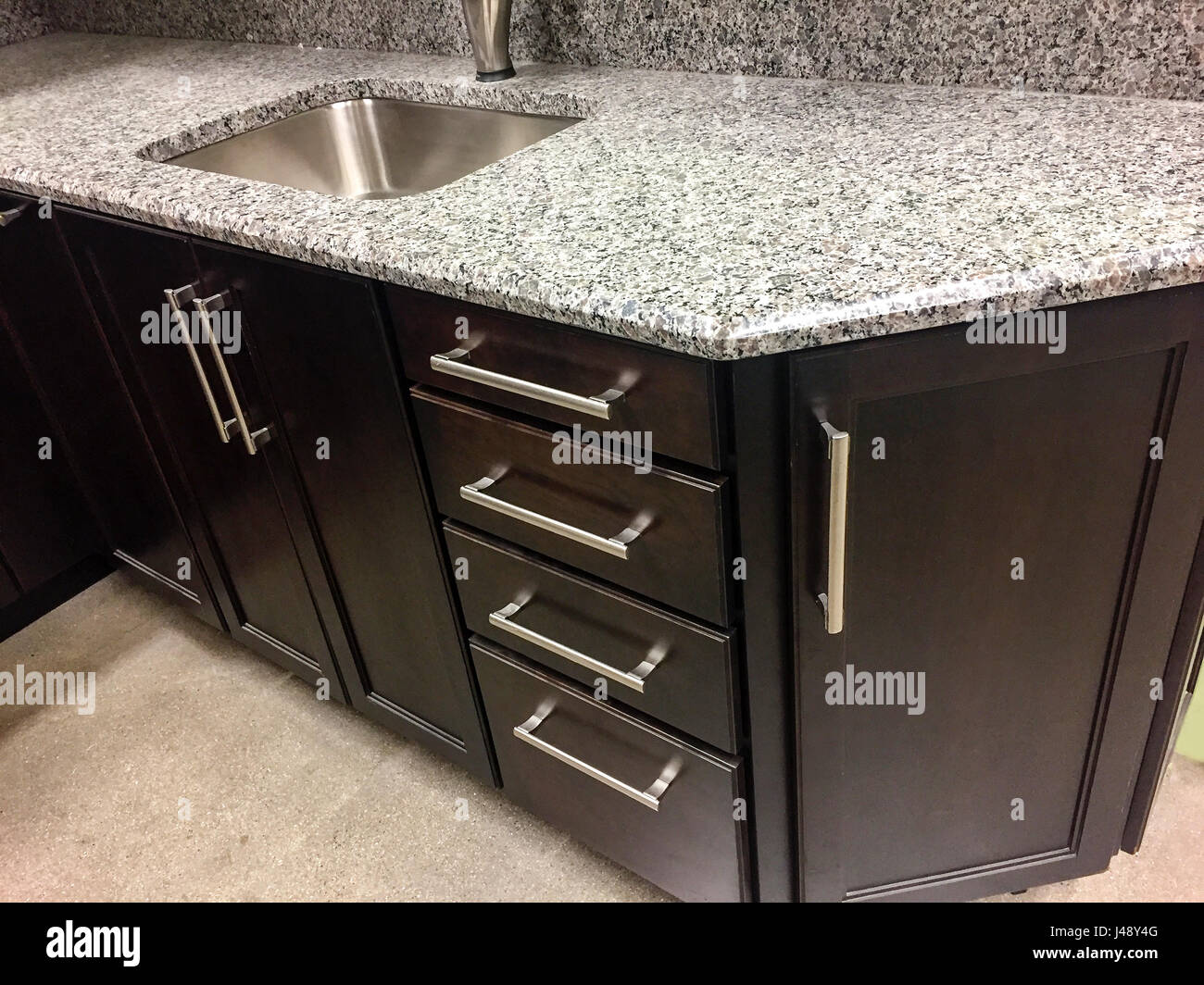 Kitchen cabinets with quartz countertop with sink and faucet Stock Photo