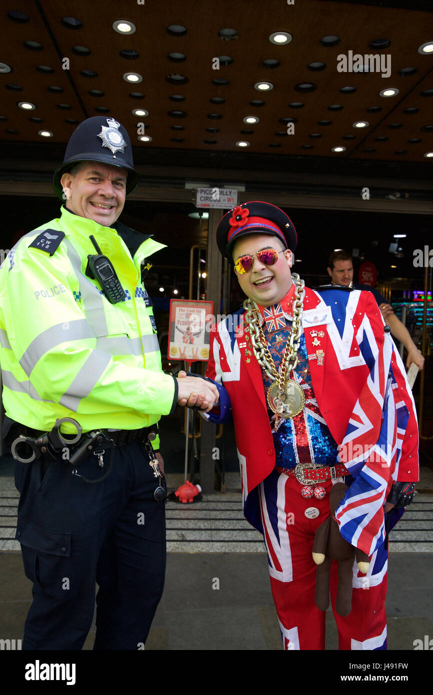 London, UK. 10th May, 2017. A police officer with a man dressed in a ...