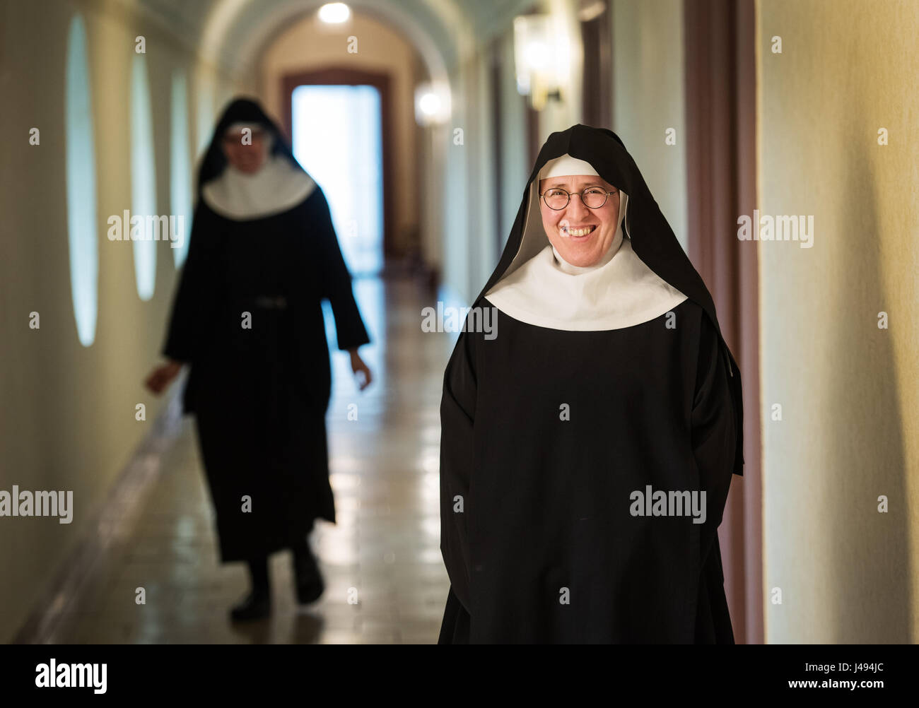 Sister Andrea Stadermann poses in her nun dress in the monastery in Rüdesheim, Germany, 02 May 2017. The sister is a nun in the Abbey Saint Hildegard in Rüdesheim and is active at the voluntary fire brigade in Rüdesheim Eibingen, Germany. Photo: Andreas Arnold/dpa Stock Photo