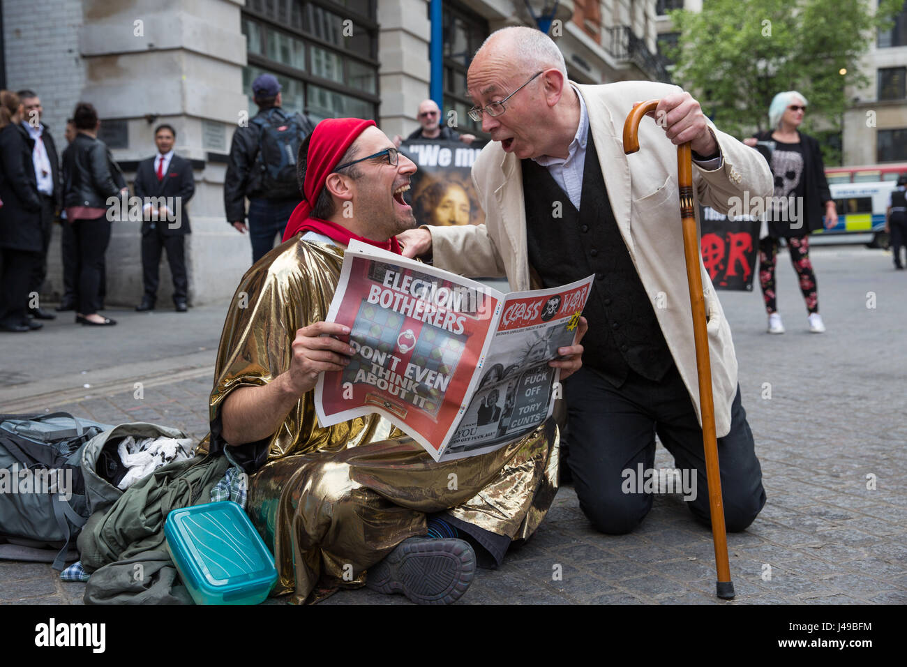 London, UK. 11th May, 2017. Ian Bone (r) of Class War shares a joke with a Life Not Money activist during a protest in solidarity with cleaners at the London School of Economics (LSE) belonging to the United Voices of the World trade union recommencing indefinite one-day-a-week strike action for parity of terms and conditions of employment with in-house staff after no offer was made to them by the LSE following the calling-off of their previous strike action. Credit: Mark Kerrison/Alamy Live News Stock Photo