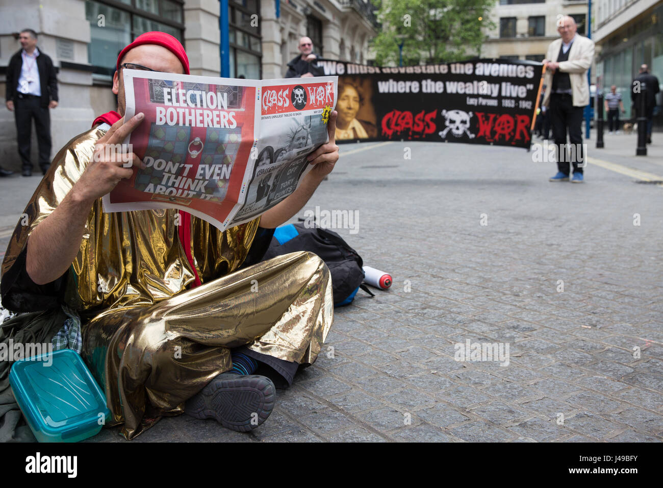 London, UK. 11th May, 2017. A Life Not Money activists reads 'Class War' newspaper during a sit-in in solidarity with cleaners at the London School of Economics (LSE) belonging to the United Voices of the World trade union recommencing indefinite one-day-a-week strike action for parity of terms and conditions of employment with in-house staff after no offer was made to them by the LSE following the calling-off of their previous strike action. Credit: Mark Kerrison/Alamy Live News Stock Photo