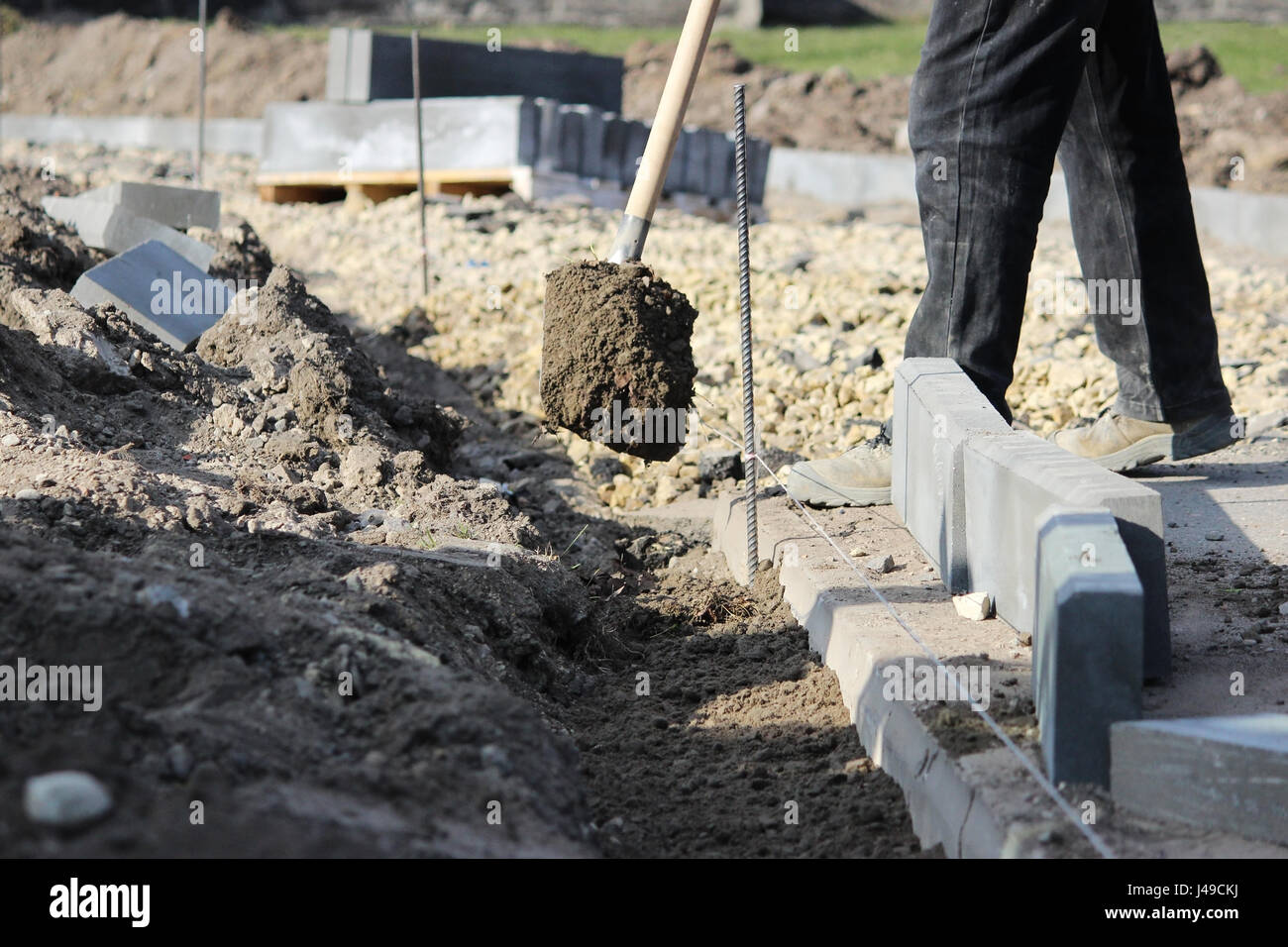 Repair of the sidewalk. Working stonemason repair the sidewalk, install