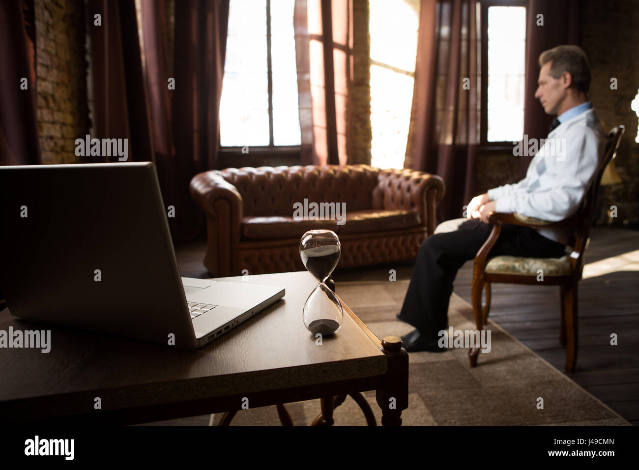 Psychology concept. Treatment of mental ailments, diseases, etc. Psychiatrist man staying in his office and waiting for patients. Stock Photo