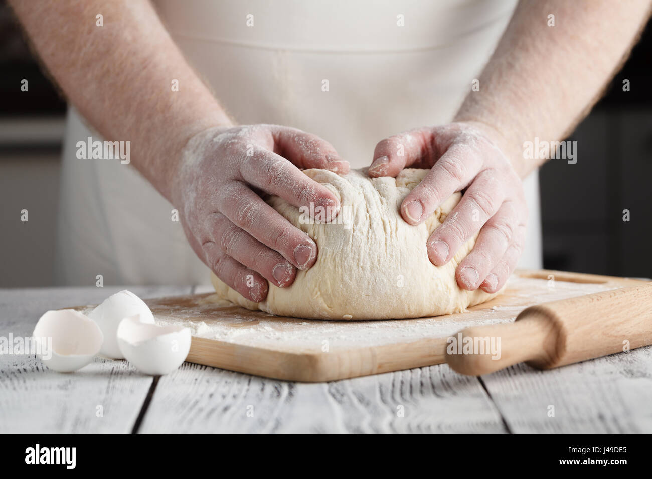 Male hands preparing dough for pizza on table closeup Stock Photo - Alamy