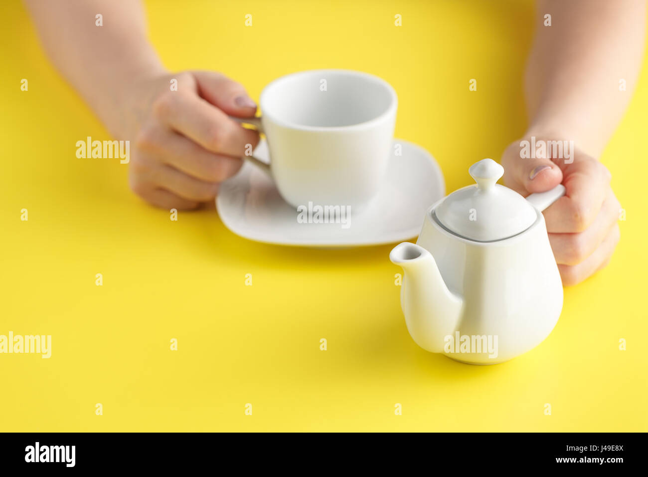 teapot pouring tea isolated on yellow background Stock Photo Alamy