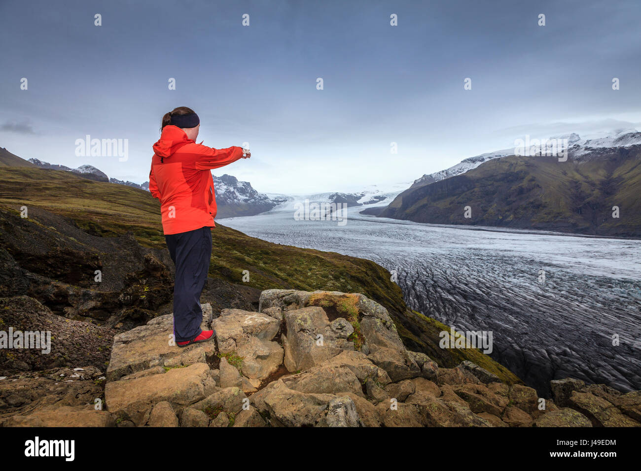 A hiker admiring view of Fjallsarlon glacier in Southern Iceland Stock Photo
