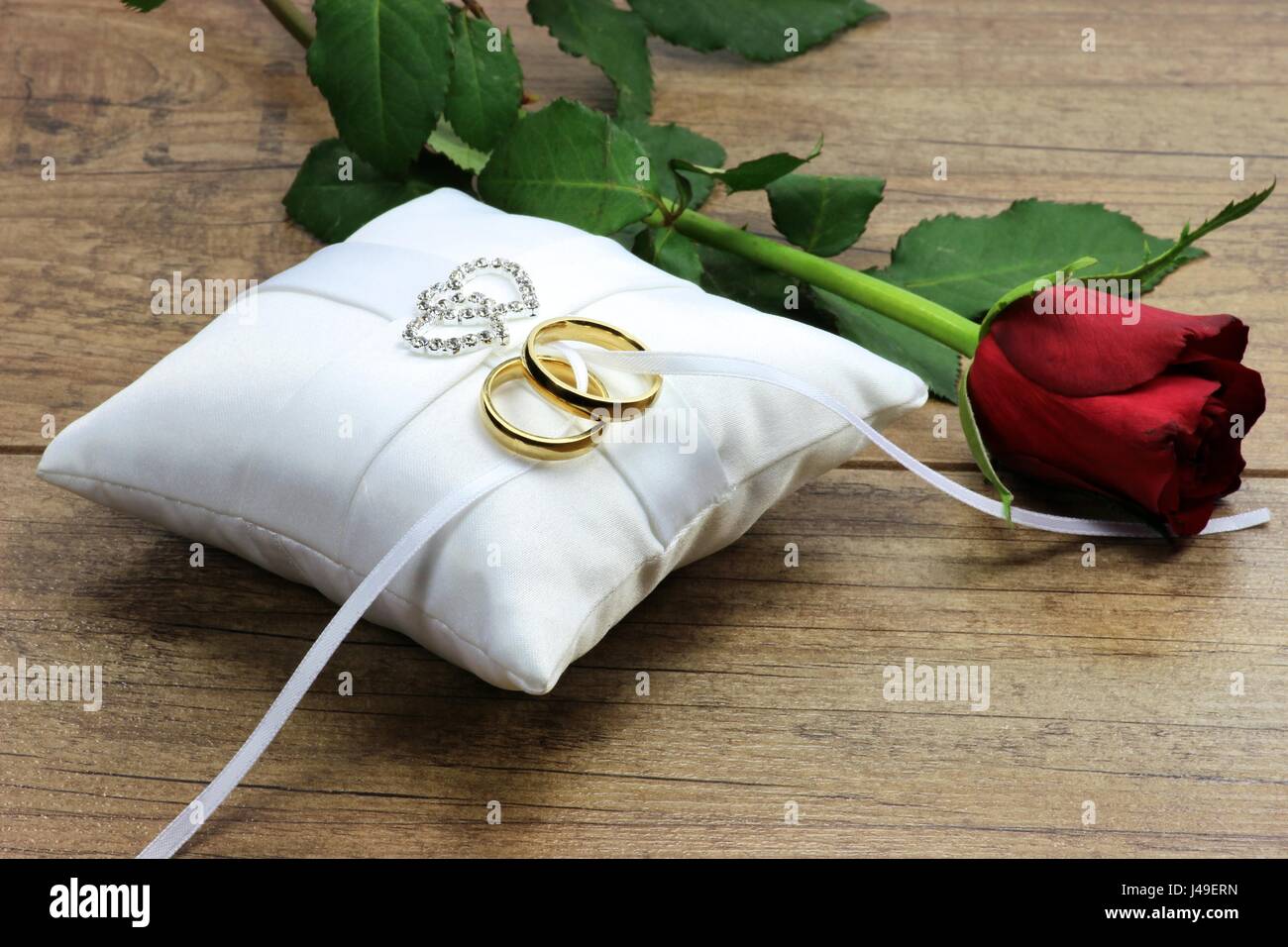 Golden Wedding Rings On White Ringbearer Pillow Stock Photo, Picture and  Royalty Free Image. Image 51171706.