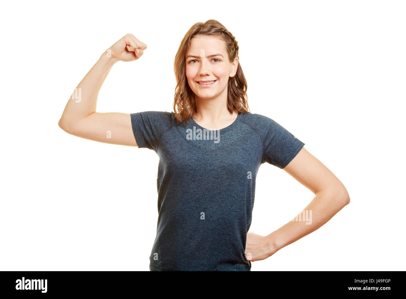 Strong young woman as Personal Trainer shows her tighten muscles Stock Photo