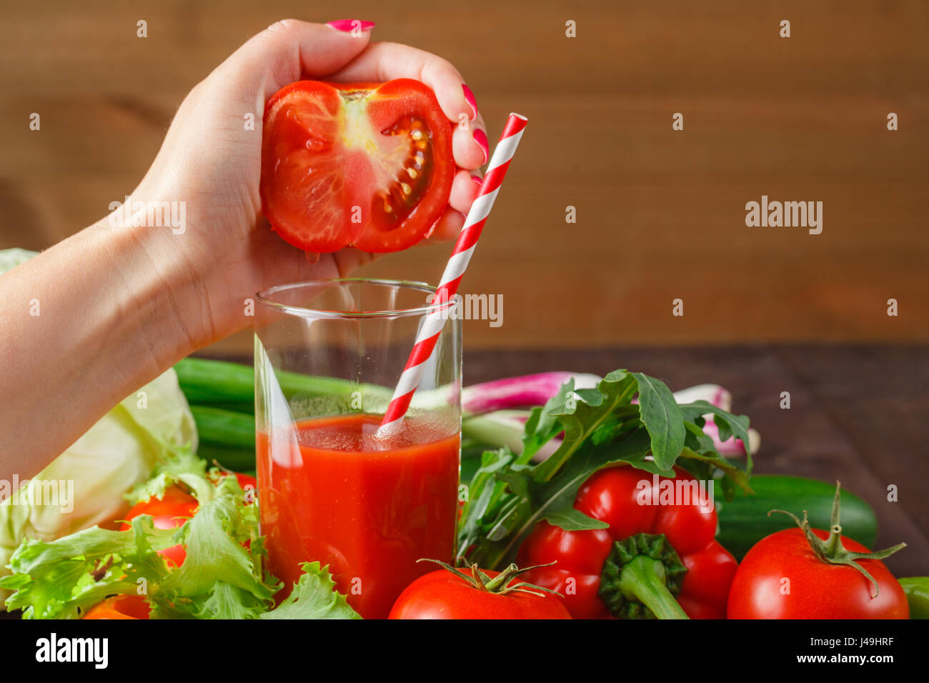 Juicing tomato juice in glass on the kitchen table Stock Photo Alamy