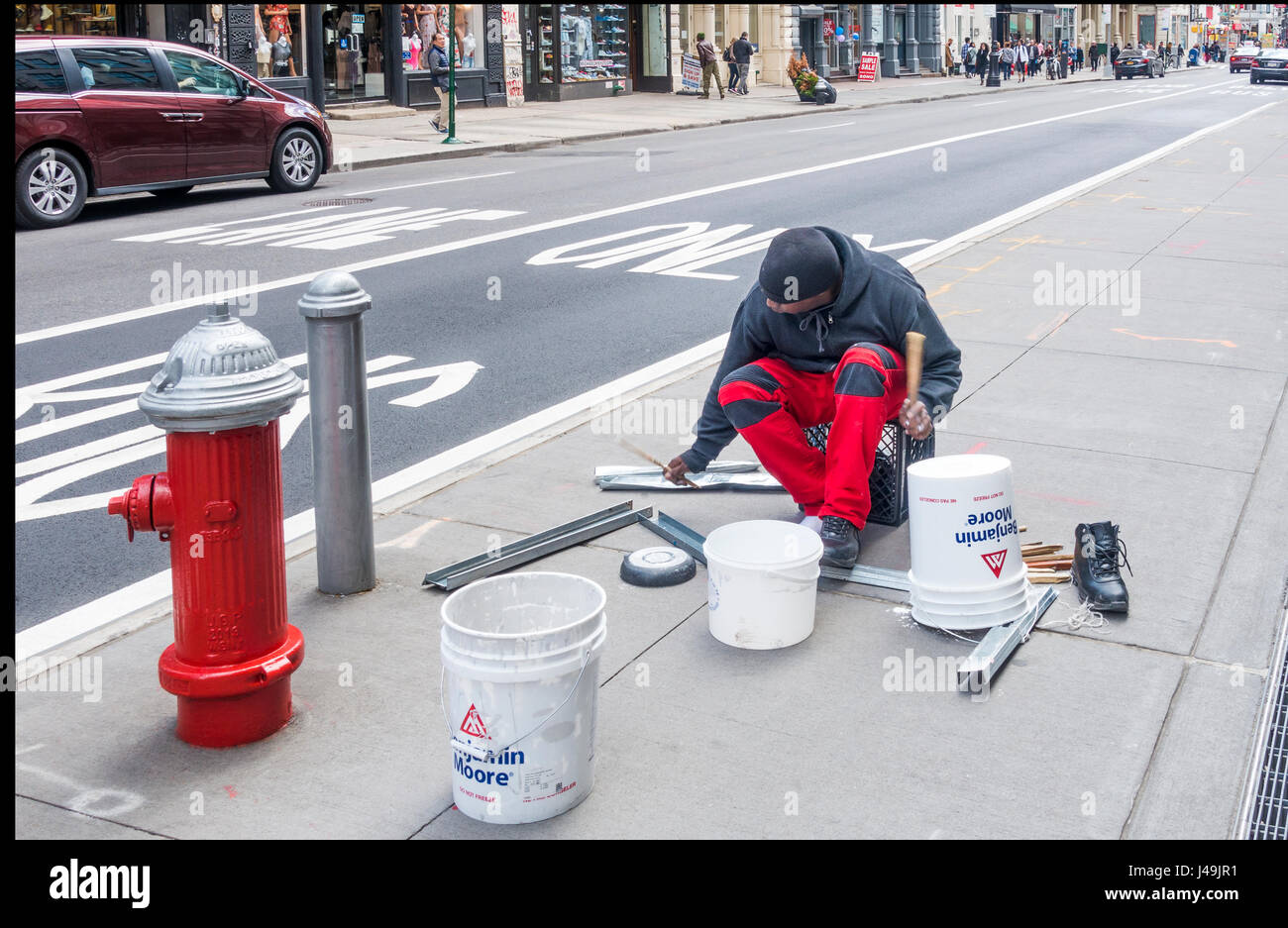 African busker drummer playing complex rhythms on plastic buckets and